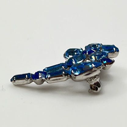 Vintage 1950s blue rhinestone flower brooch in silver-tone setting