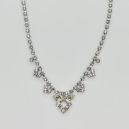 Full view of crystal necklace with prong-set rhinestones on white background