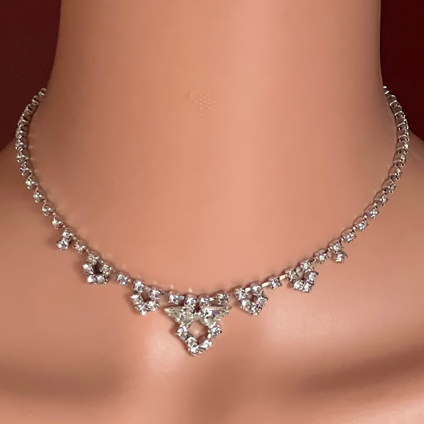 Model wearing 1950s rhinestone necklace with geometric drop center