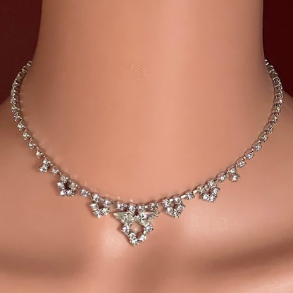 Model wearing 1950s rhinestone necklace with geometric drop center