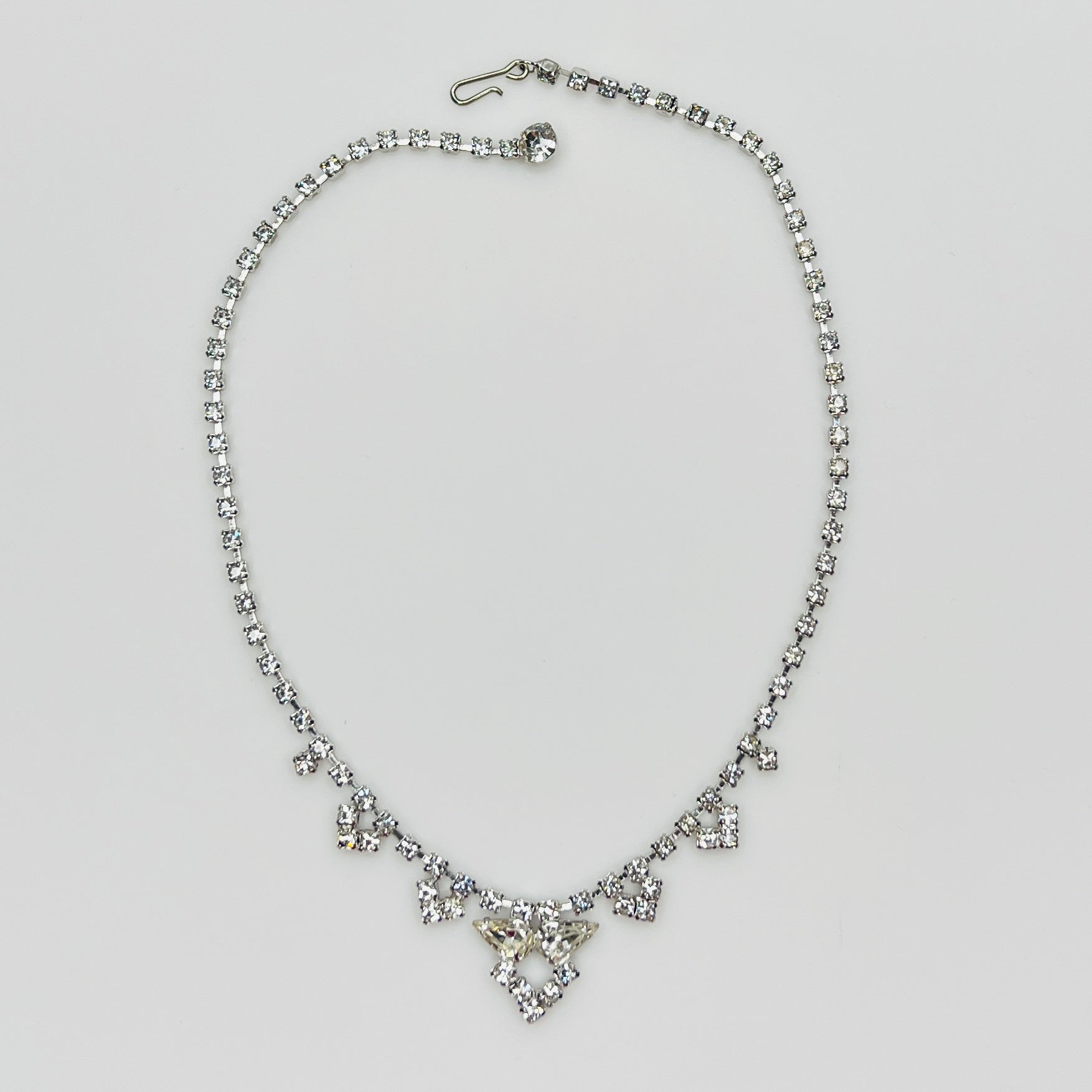 Necklace laid flat showing hook clasp and rhinestone extender