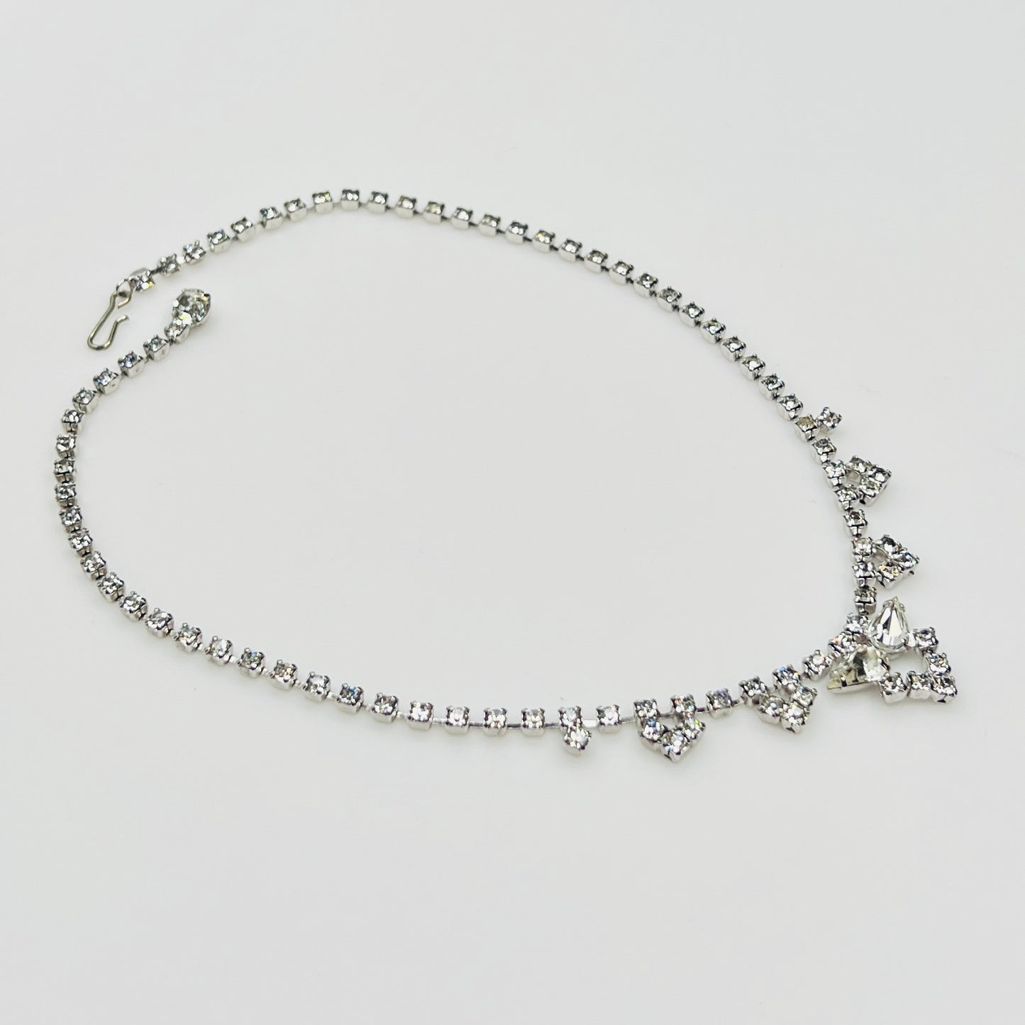 Necklace laid flat showing hook clasp and rhinestone extender