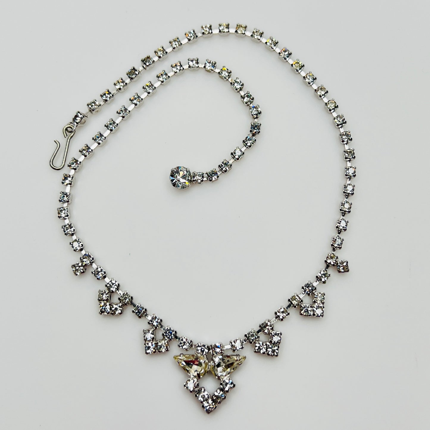 Necklace laid flat showing hook clasp and rhinestone extender