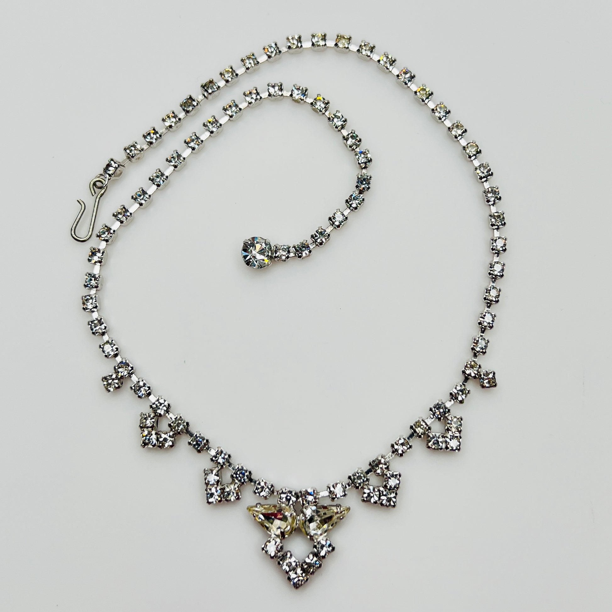 Necklace laid flat showing hook clasp and rhinestone extender