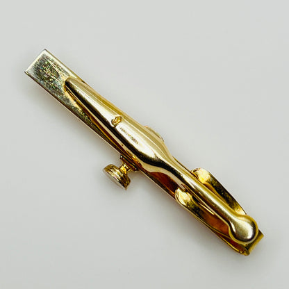 back view 1950s gold-tone tie clip with vintage microphone motif showing S stamp