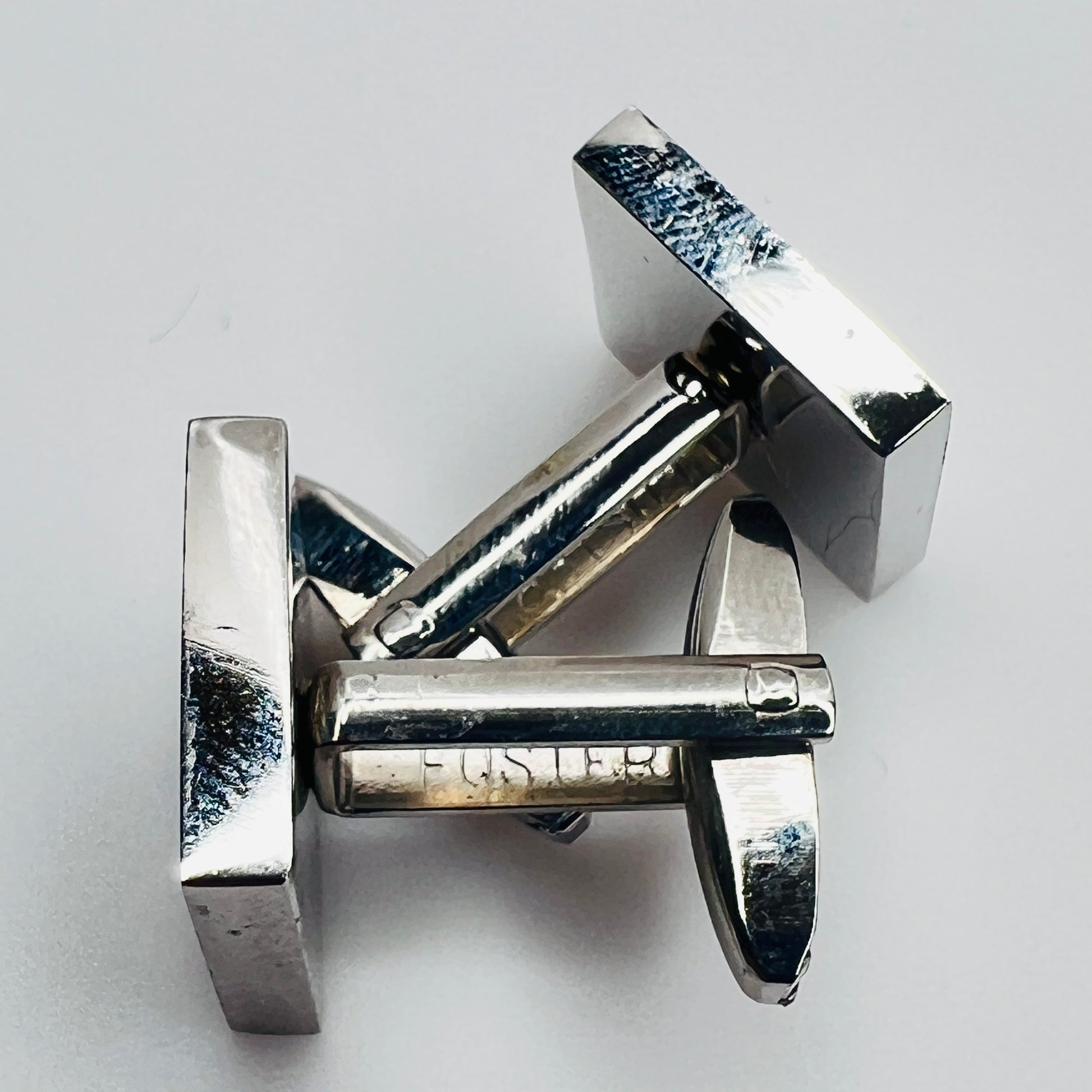 Close-up of cufflink shank marked “Foster”