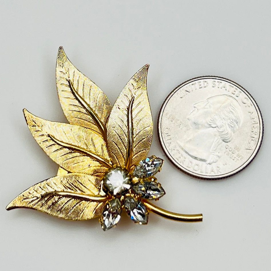 Vintage leaf brooch with quarter for scale and crystal center cluster