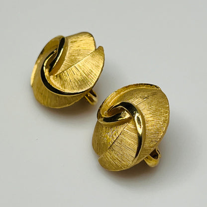 Crown Trifari gold-tone clip-on earrings with swirl design, brushed and polished finish
