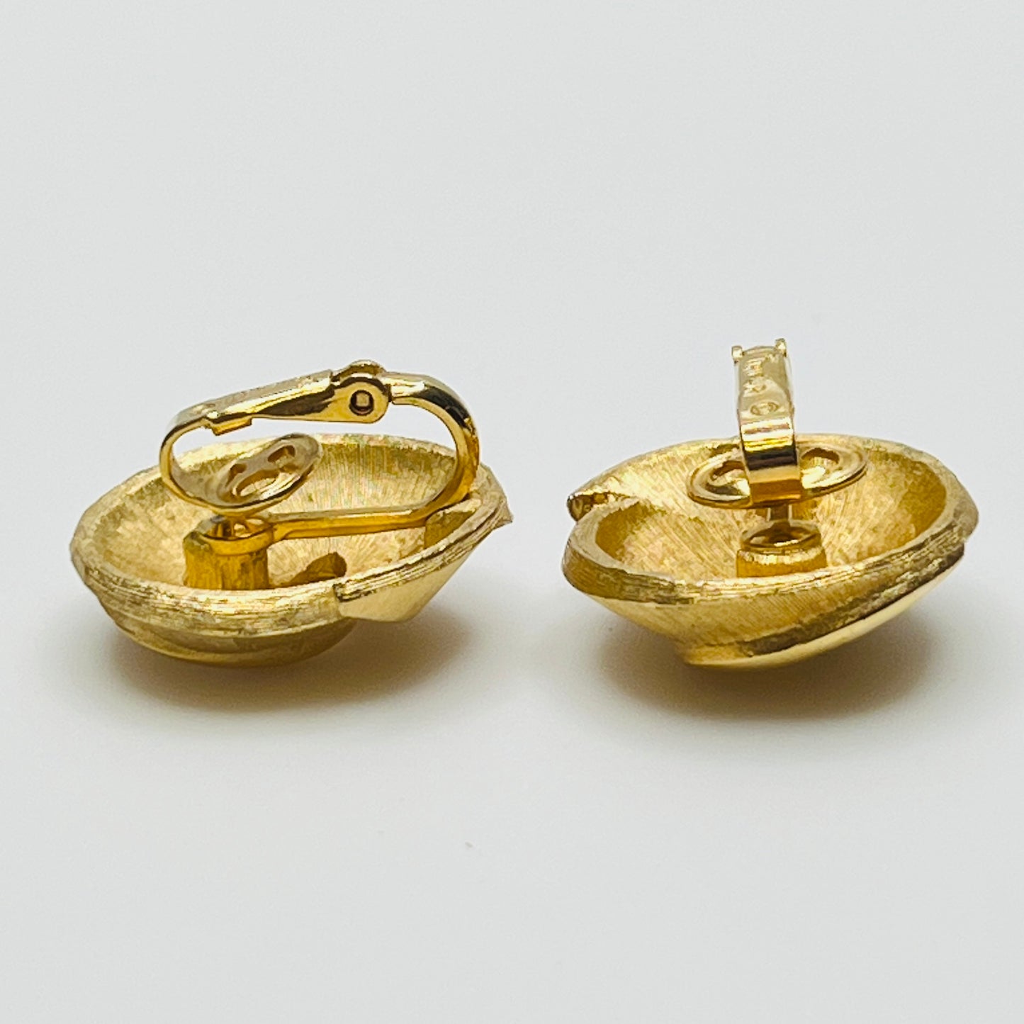 Crown Trifari gold-tone clip-on earrings with swirl design, brushed and polished finish