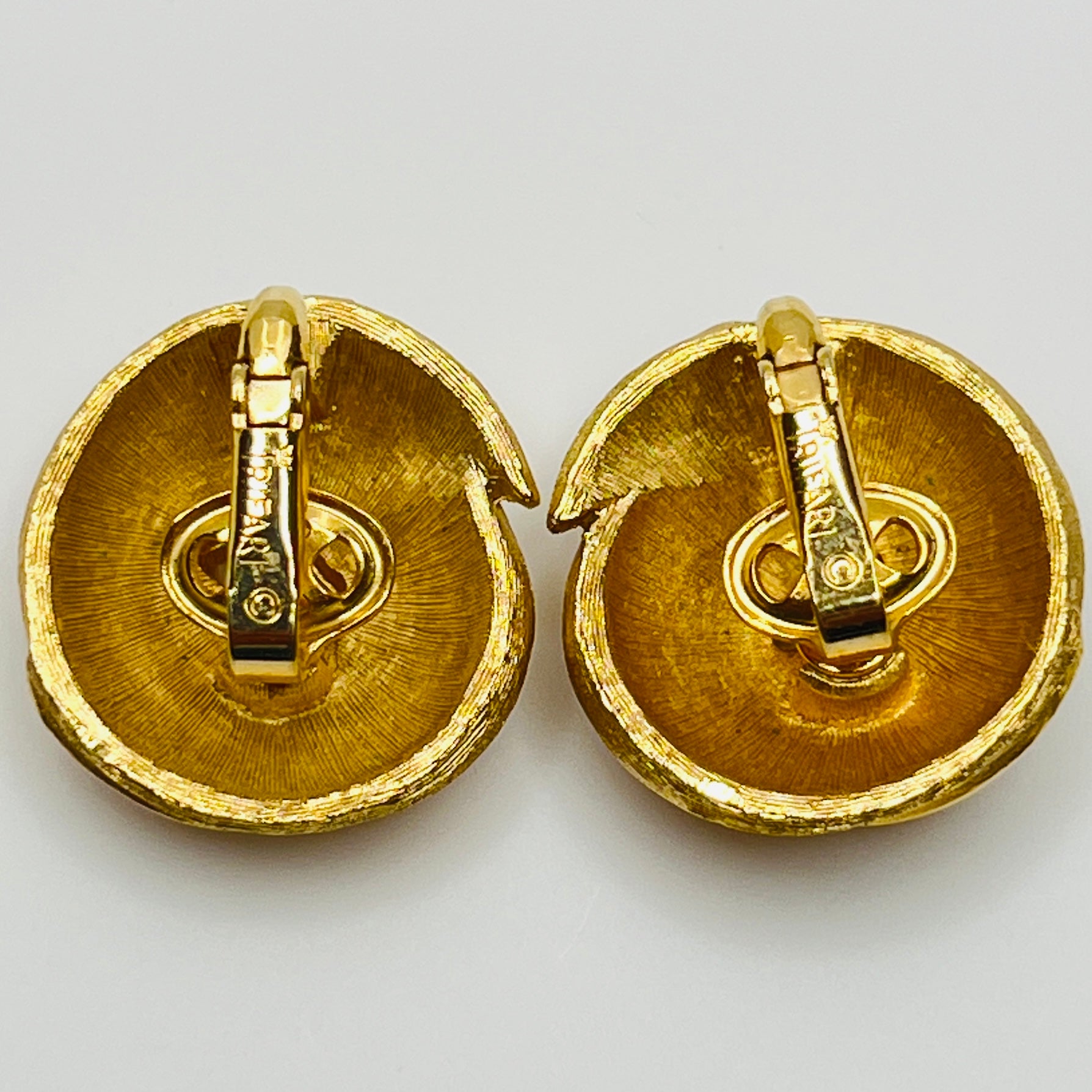 Crown Trifari gold-tone clip-on earrings with swirl design, brushed and polished finish