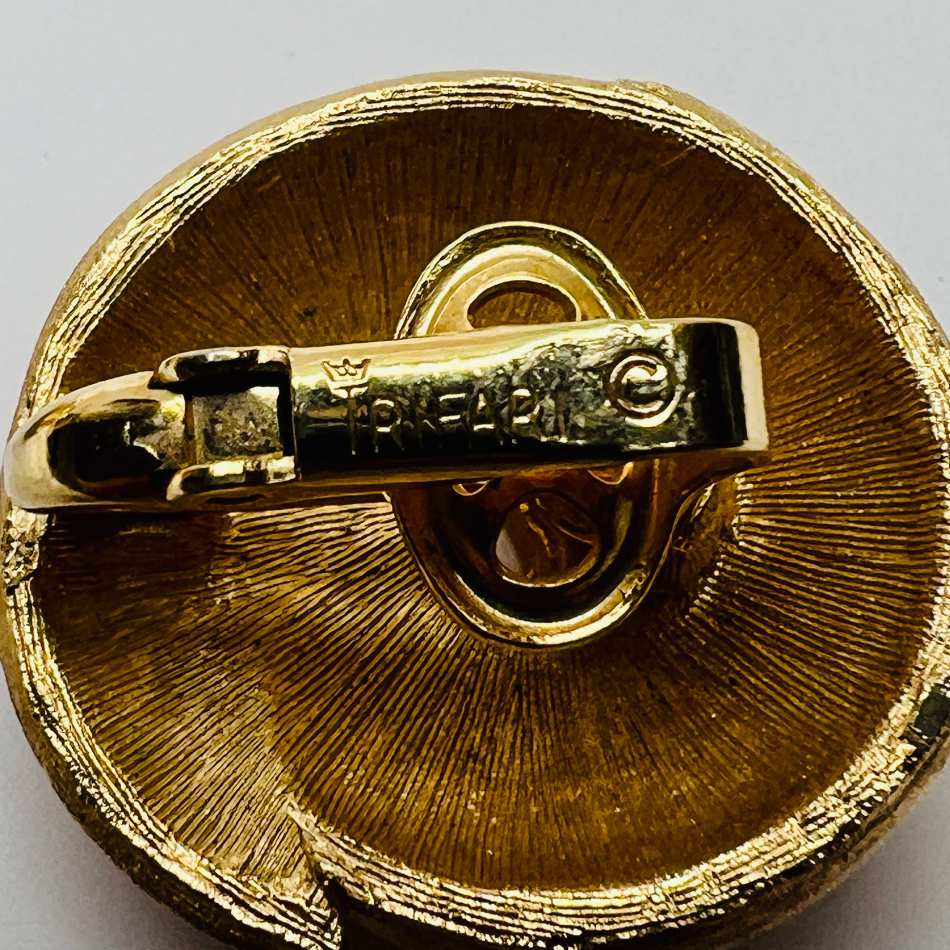 Crown Trifari gold-tone clip-on earrings with swirl design, brushed and polished finish