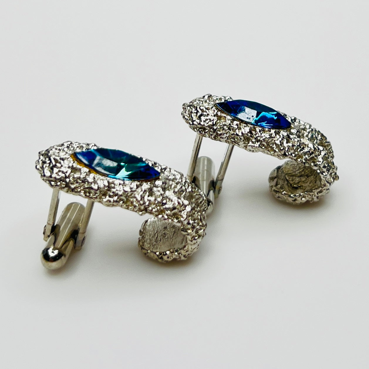 Side view of vintage cufflinks showing bullet back closure