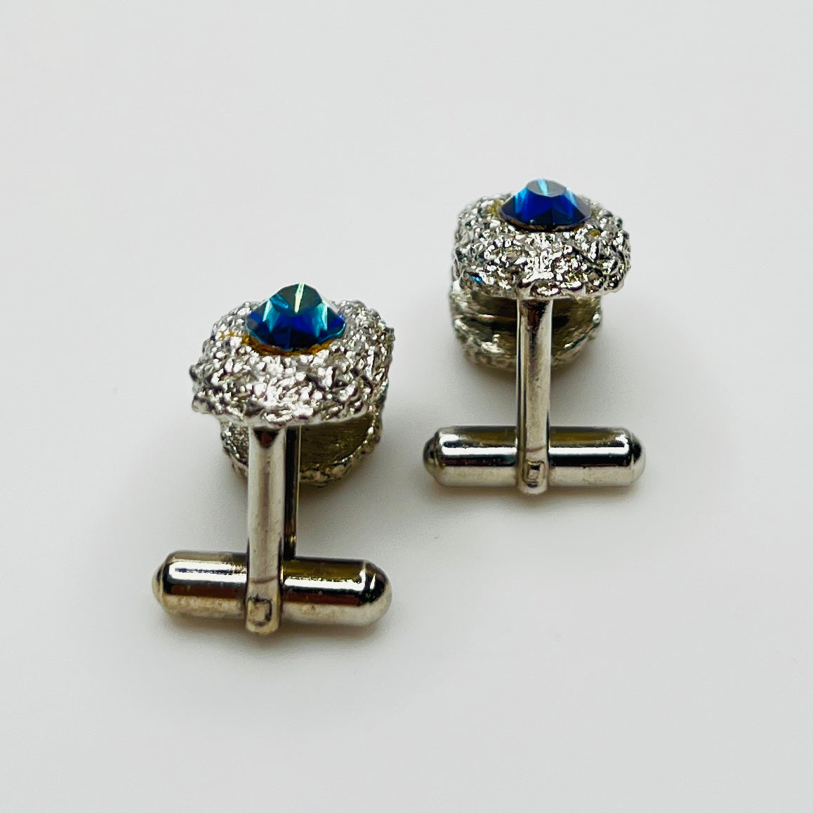 Side view of vintage cufflinks showing bullet back closure