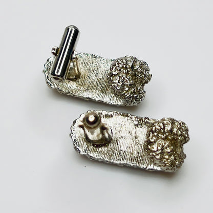 Back of silver cufflinks showing textured construction