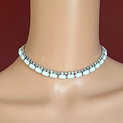1950s milk glass and rhinestone choker necklace with silver-tone setting and hook closure.