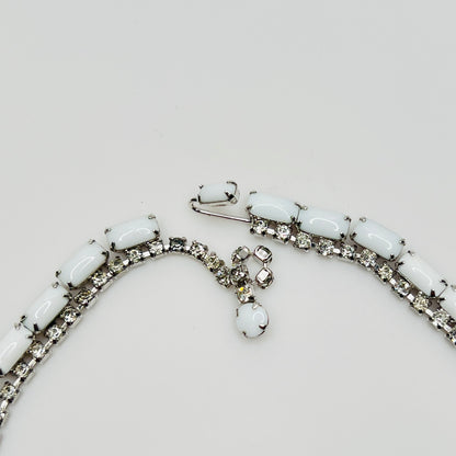 1950s milk glass and rhinestone choker necklace with silver-tone setting and hook closure.