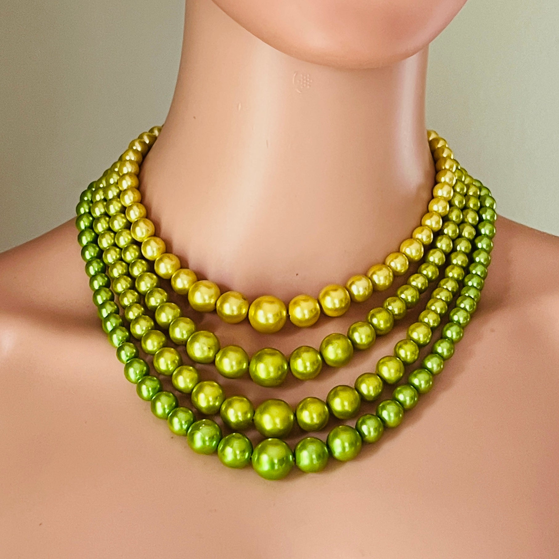 1950s layered lime green and yellow pearl necklace on mannequin