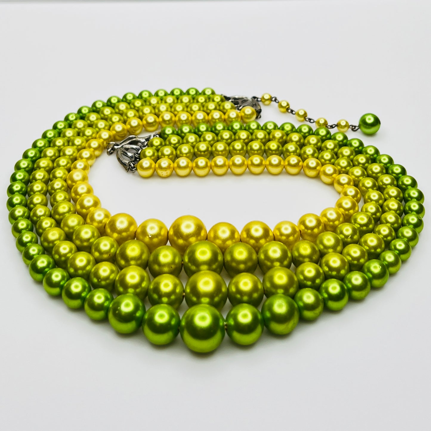Close-up of green and yellow faux pearls with gradient tones