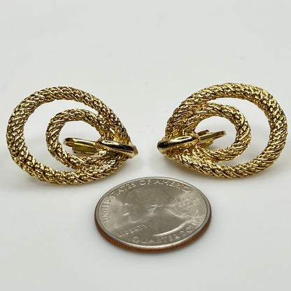 Clip-on earrings with quarter for scale, twisted double-loop design
