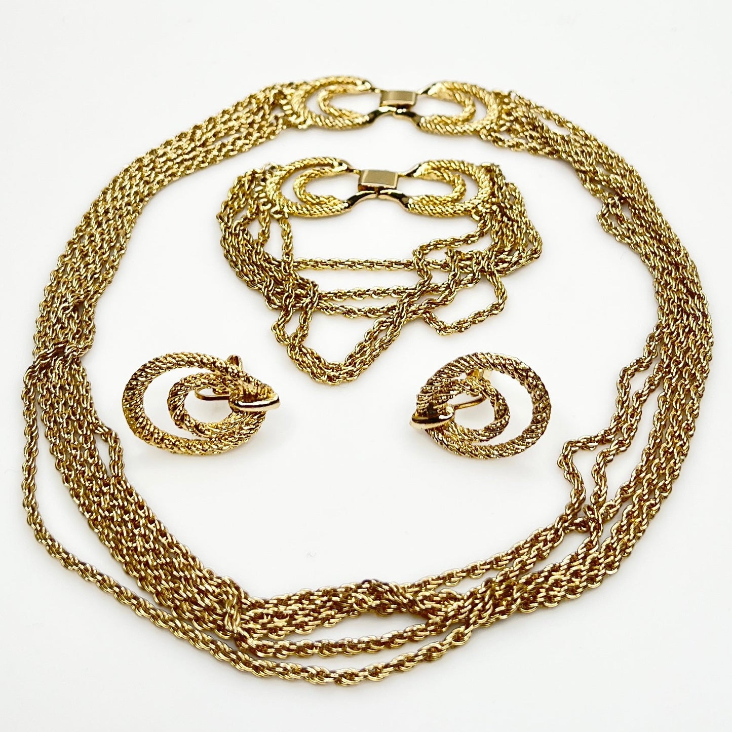 Three-piece vintage gold chain jewelry set with necklace, bracelet, and earrings