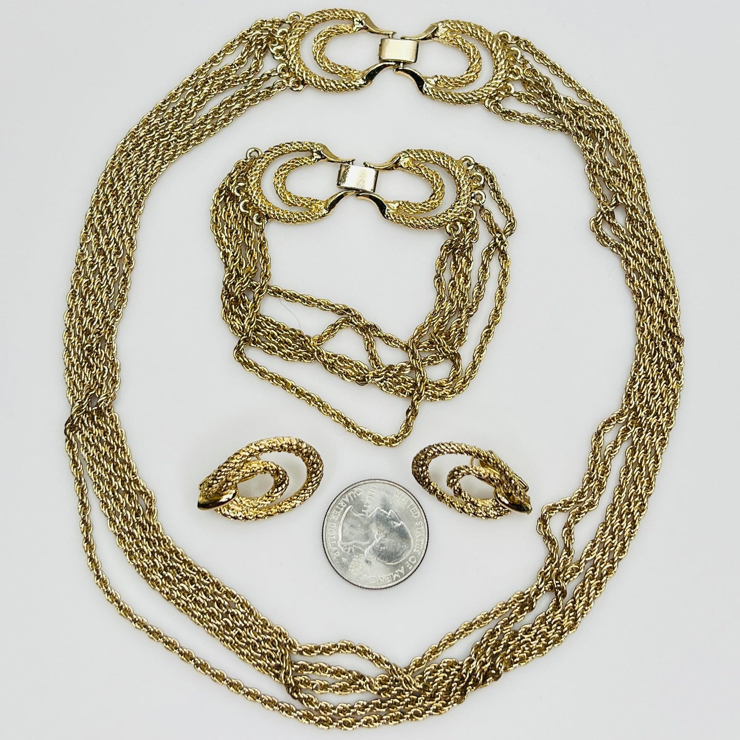 Three-piece vintage gold chain jewelry set with necklace, bracelet, and earrings