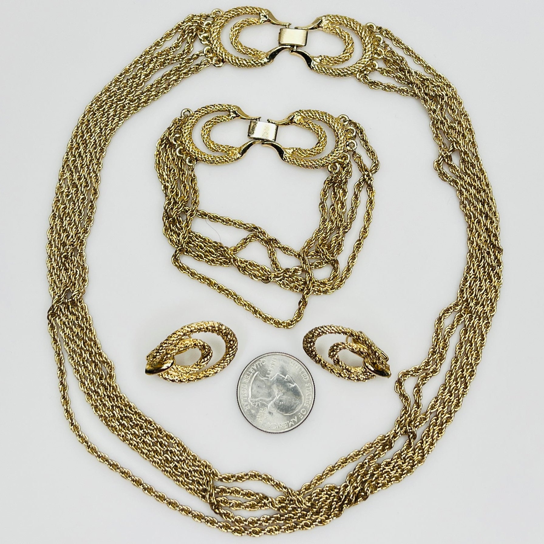 Three-piece vintage gold chain jewelry set with necklace, bracelet, and earrings
