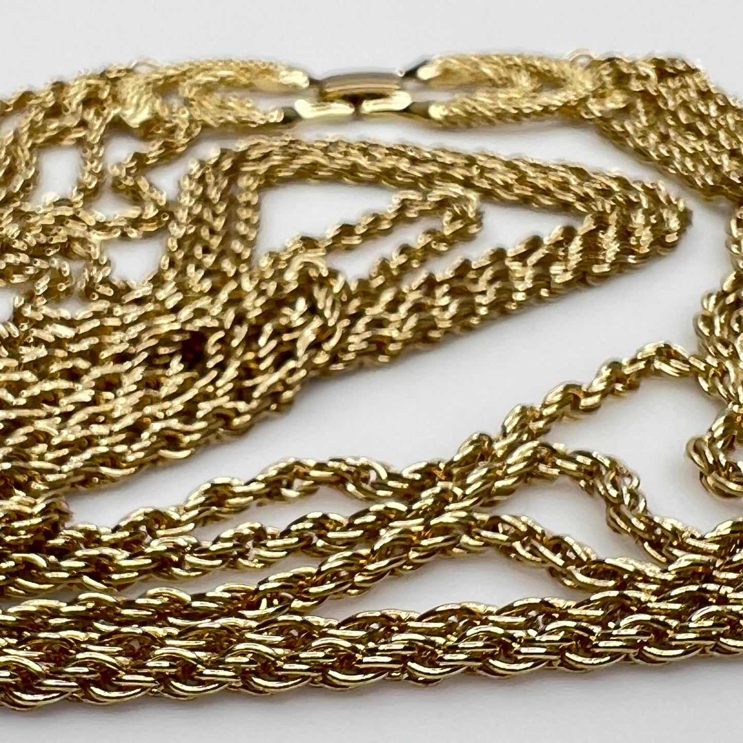 close up of gold tone chain of necklace and bracelet