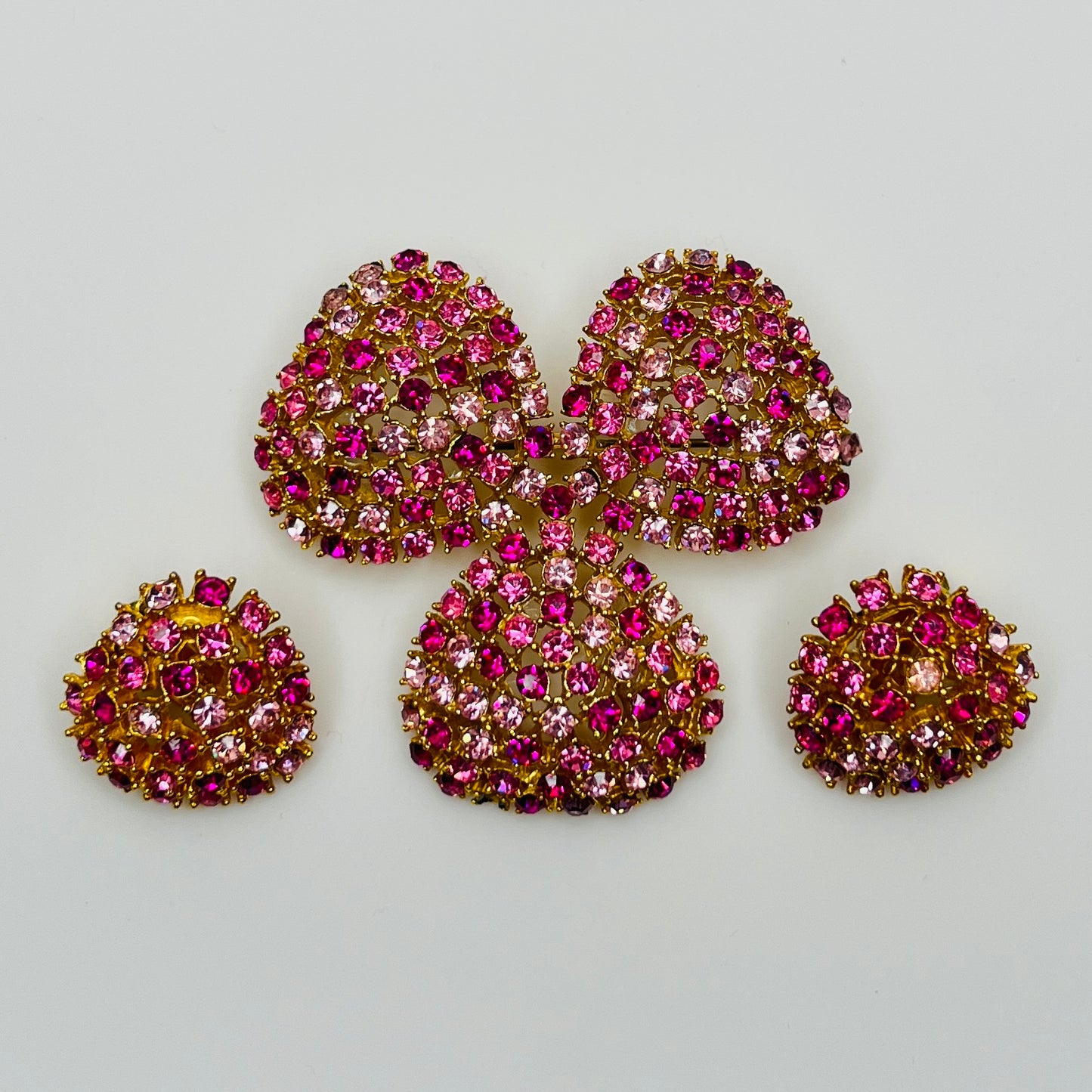 Vintage gold-tone brooch and clip-on earrings with pink rhinestones, mid-century jewelry set