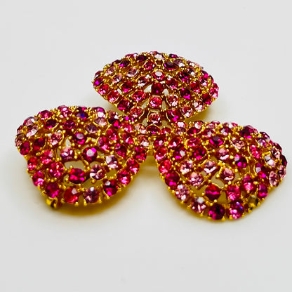 Vintage gold-tone brooch and clip-on earrings with pink rhinestones, mid-century jewelry set