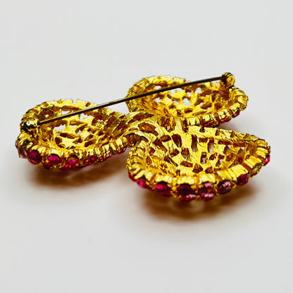 Vintage gold-tone brooch and clip-on earrings with pink rhinestones, mid-century jewelry set