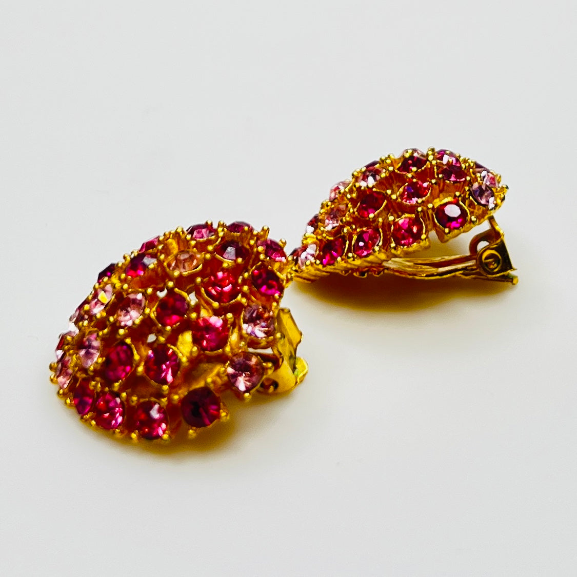 Vintage gold-tone brooch and clip-on earrings with pink rhinestones, mid-century jewelry set