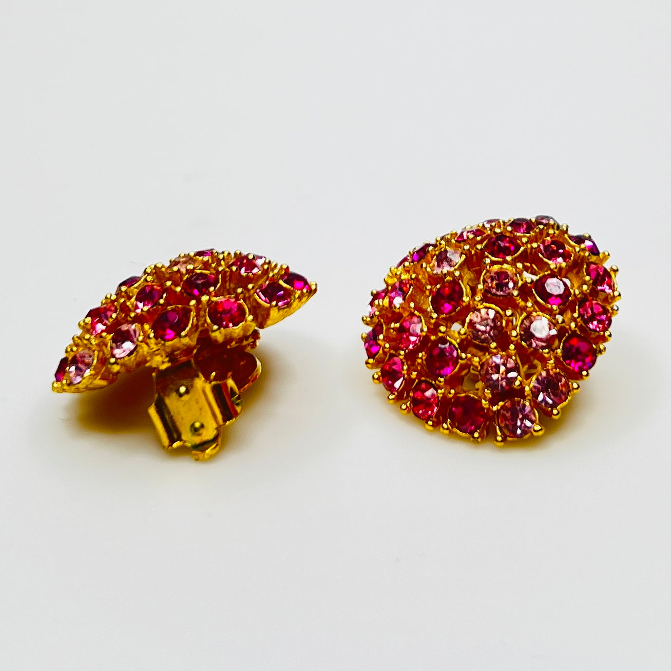 Vintage gold-tone brooch and clip-on earrings with pink rhinestones, mid-century jewelry set