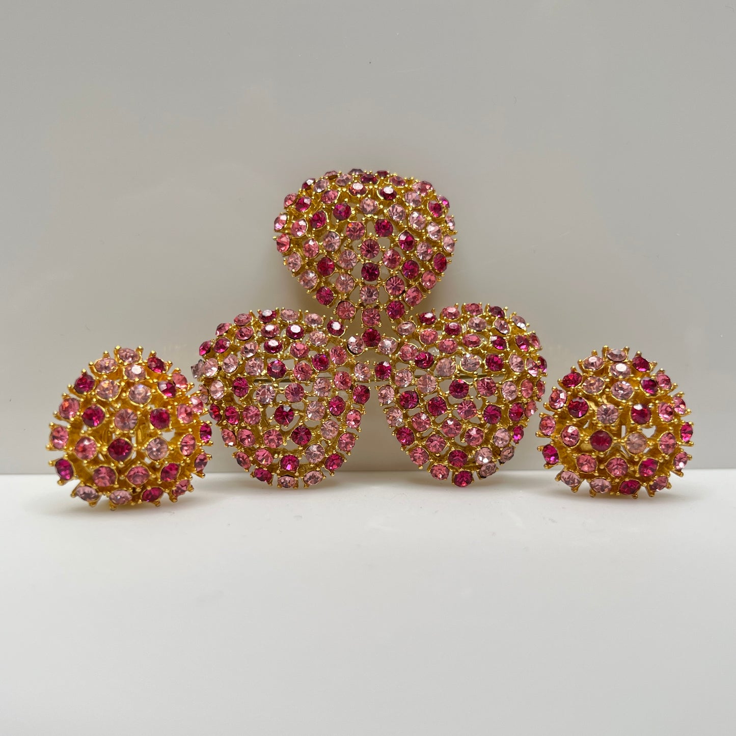 Vintage gold-tone brooch and clip-on earrings with pink rhinestones, mid-century jewelry set