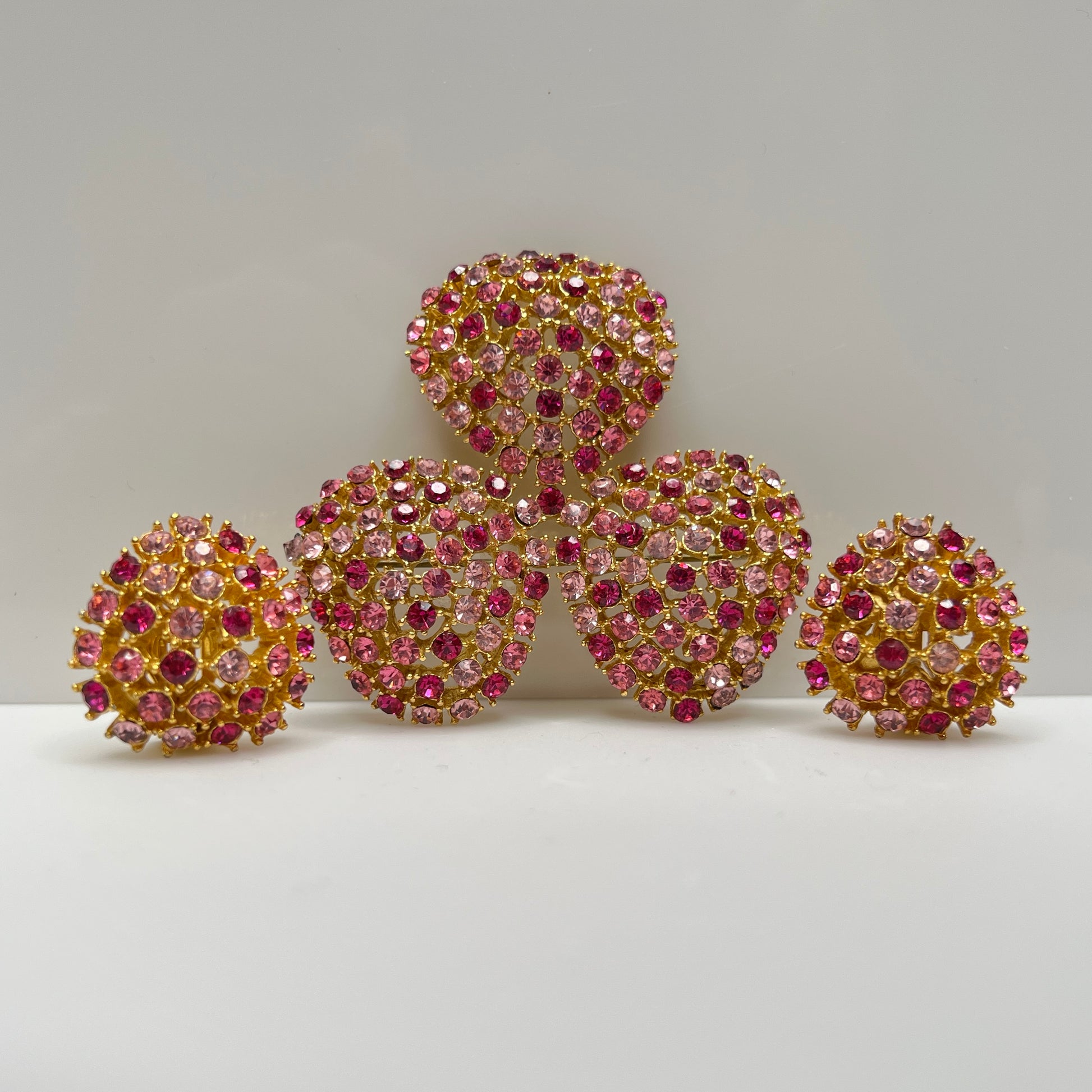 Vintage gold-tone brooch and clip-on earrings with pink rhinestones, mid-century jewelry set