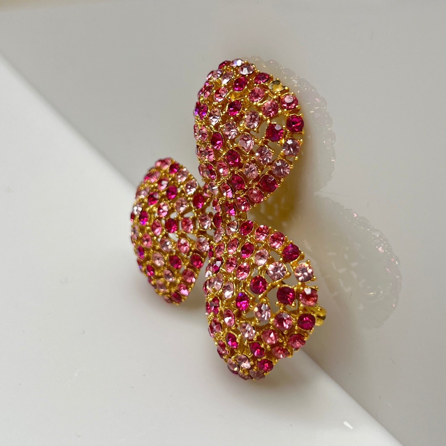 Vintage gold-tone brooch and clip-on earrings with pink rhinestones, mid-century jewelry set