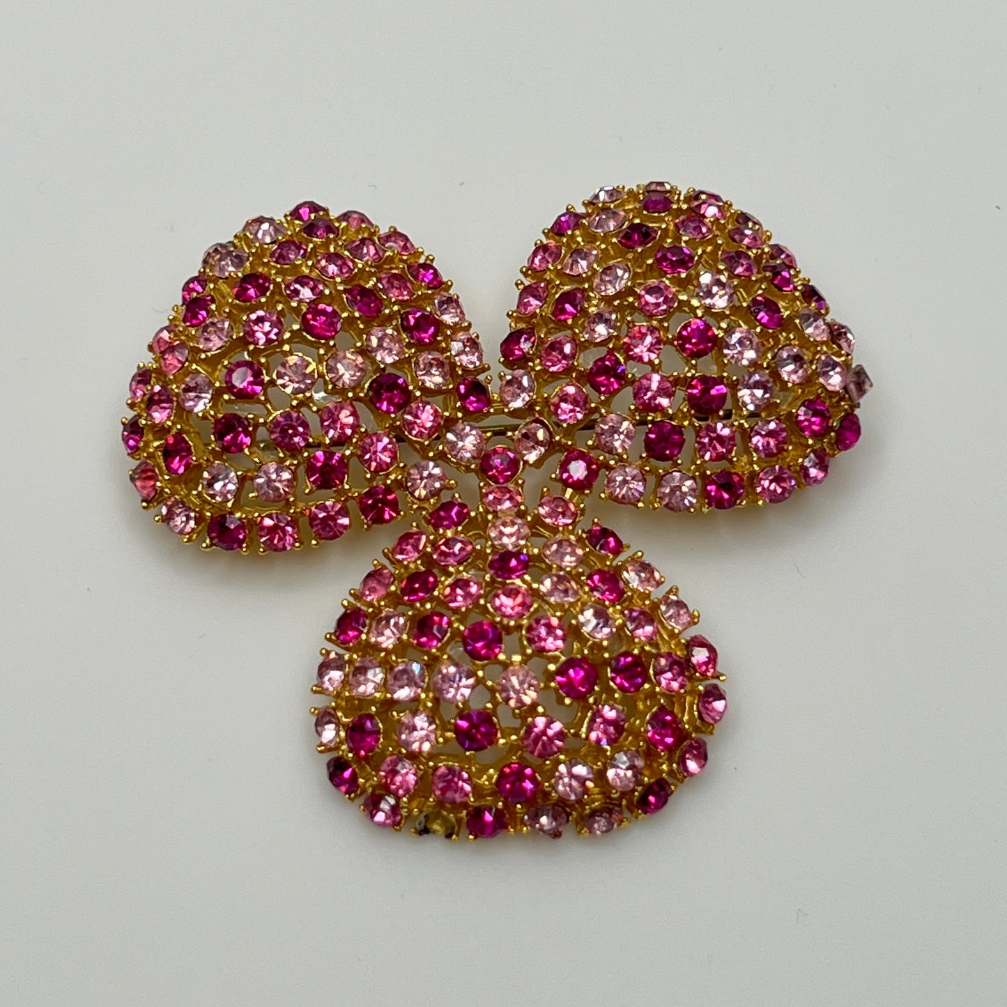 Vintage gold-tone brooch and clip-on earrings with pink rhinestones, mid-century jewelry set