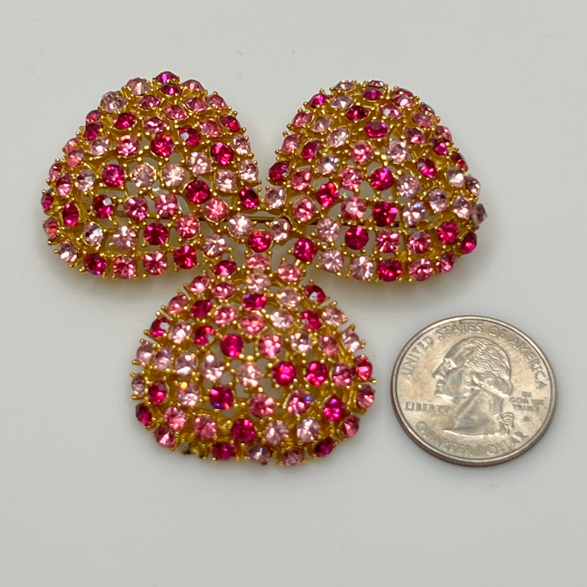 Vintage gold-tone brooch and clip-on earrings with pink rhinestones, mid-century jewelry set