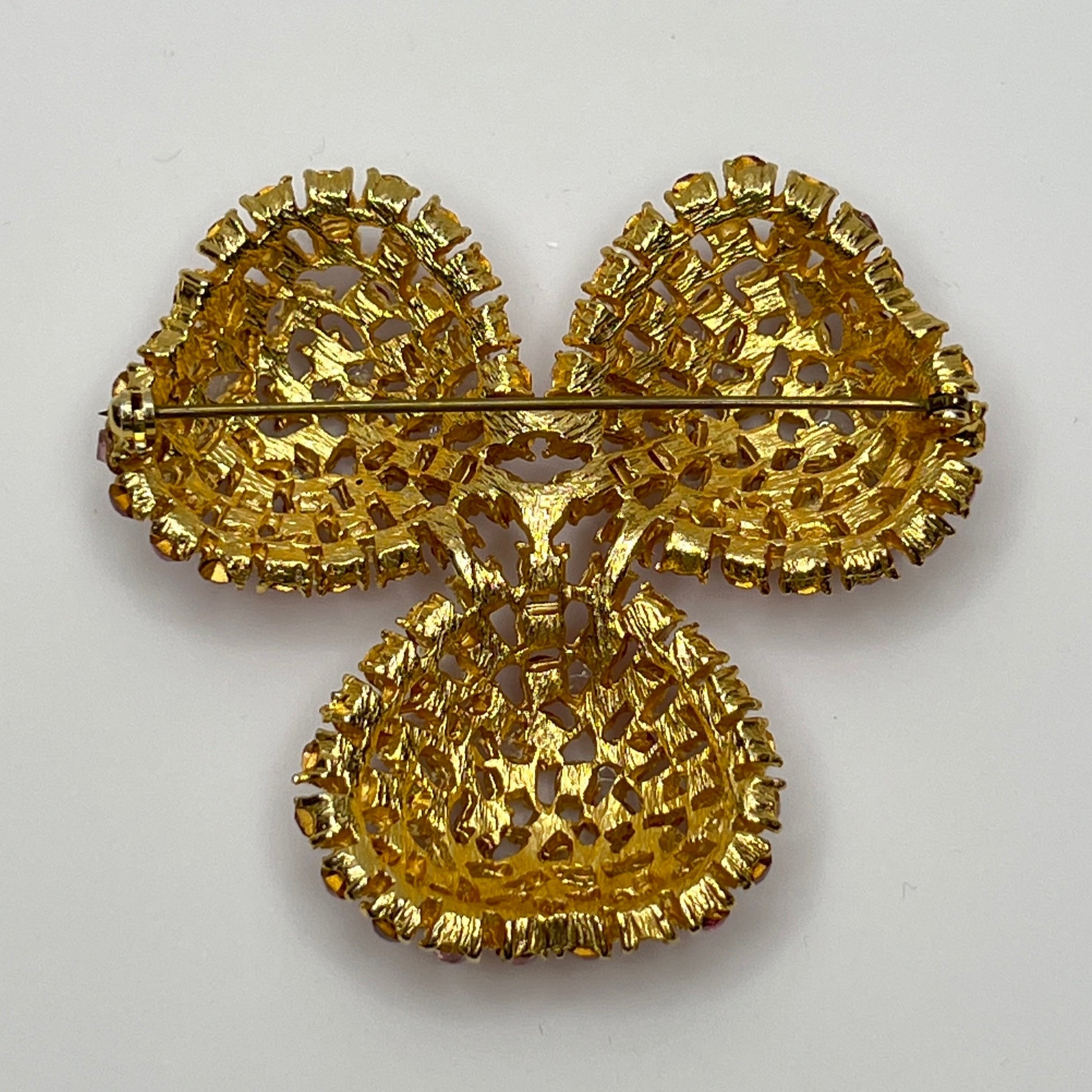 Vintage gold-tone brooch and clip-on earrings with pink rhinestones, mid-century jewelry set