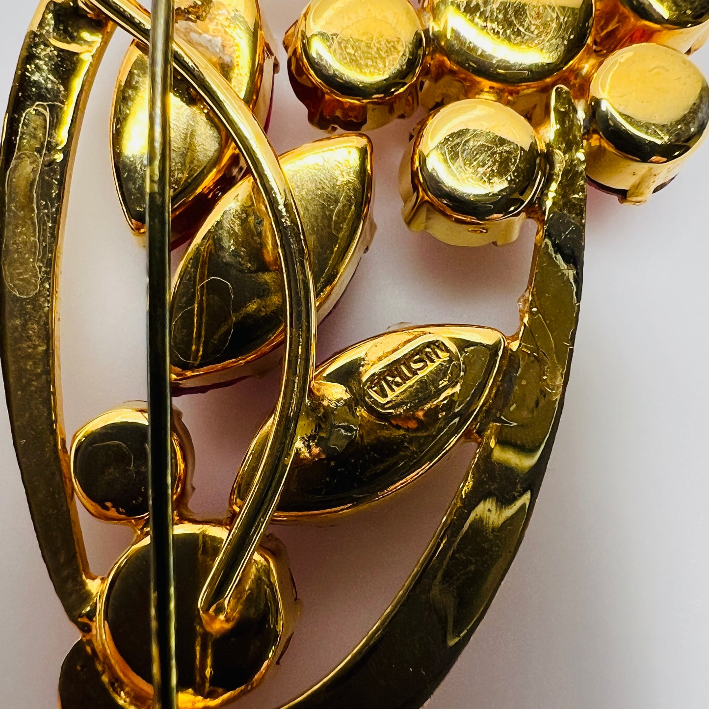 back view of red rhinestone floral brooch with prong-set crystals