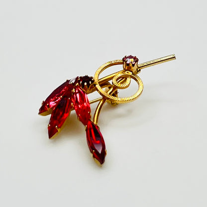 1950s pink rhinestone brooch with gold-tone spiral and navette stones