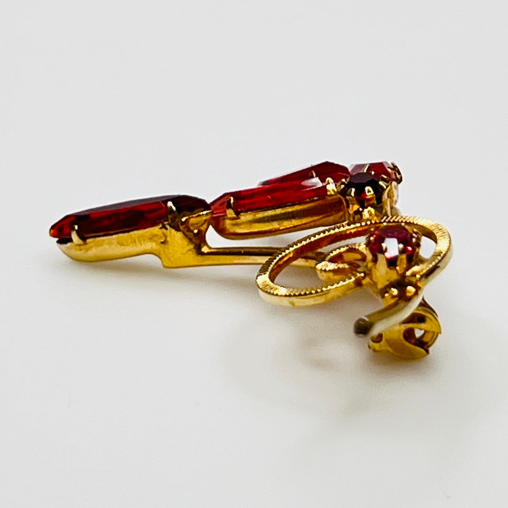 1950s pink rhinestone brooch with gold-tone spiral and navette stones