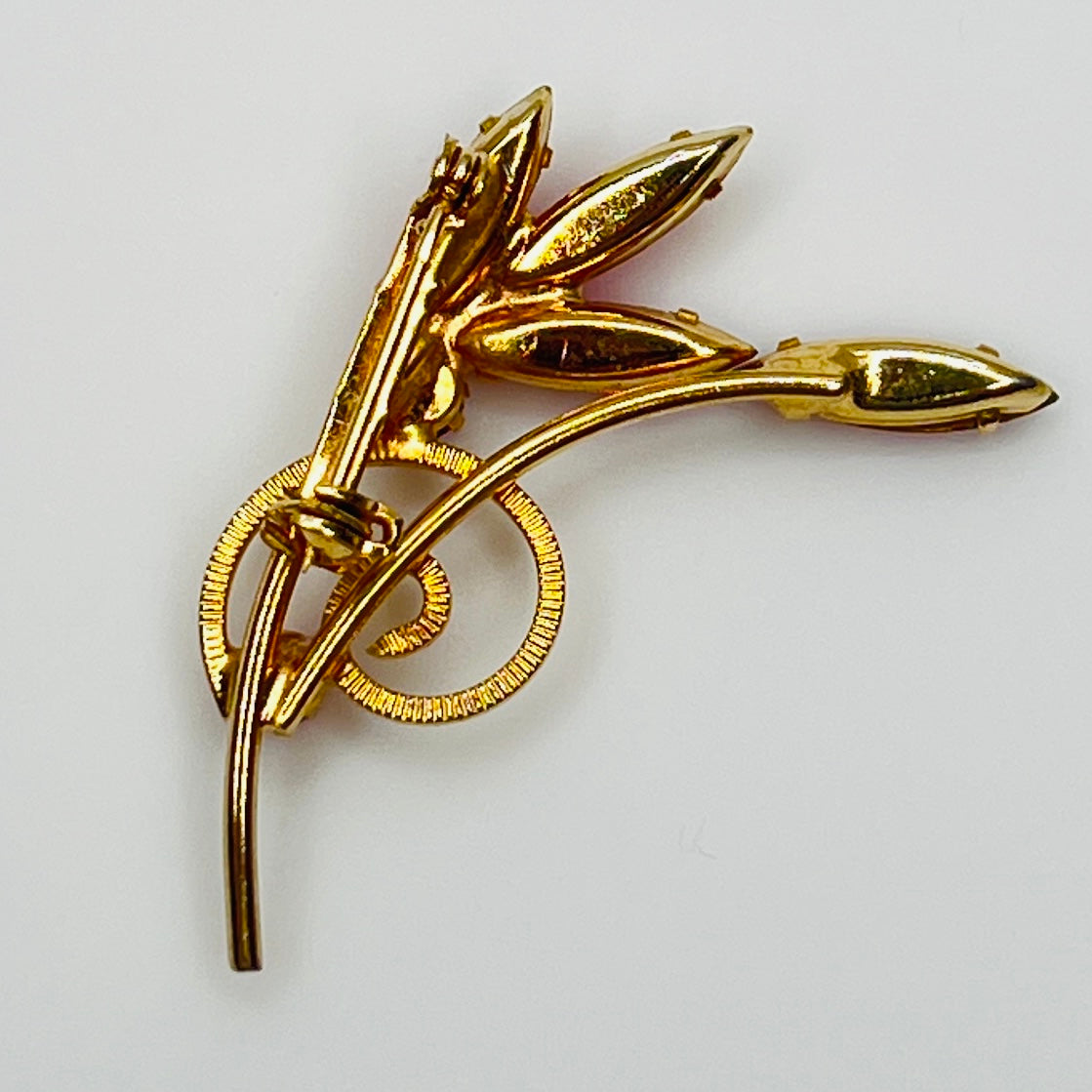 Back view of gold-tone mid-century rhinestone brooch