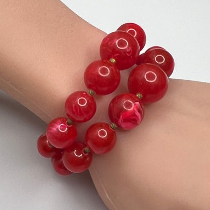 Red lucite wrap bracelet with double strands shown on wrist