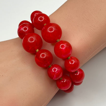 Red lucite wrap bracelet with double strands shown on wrist