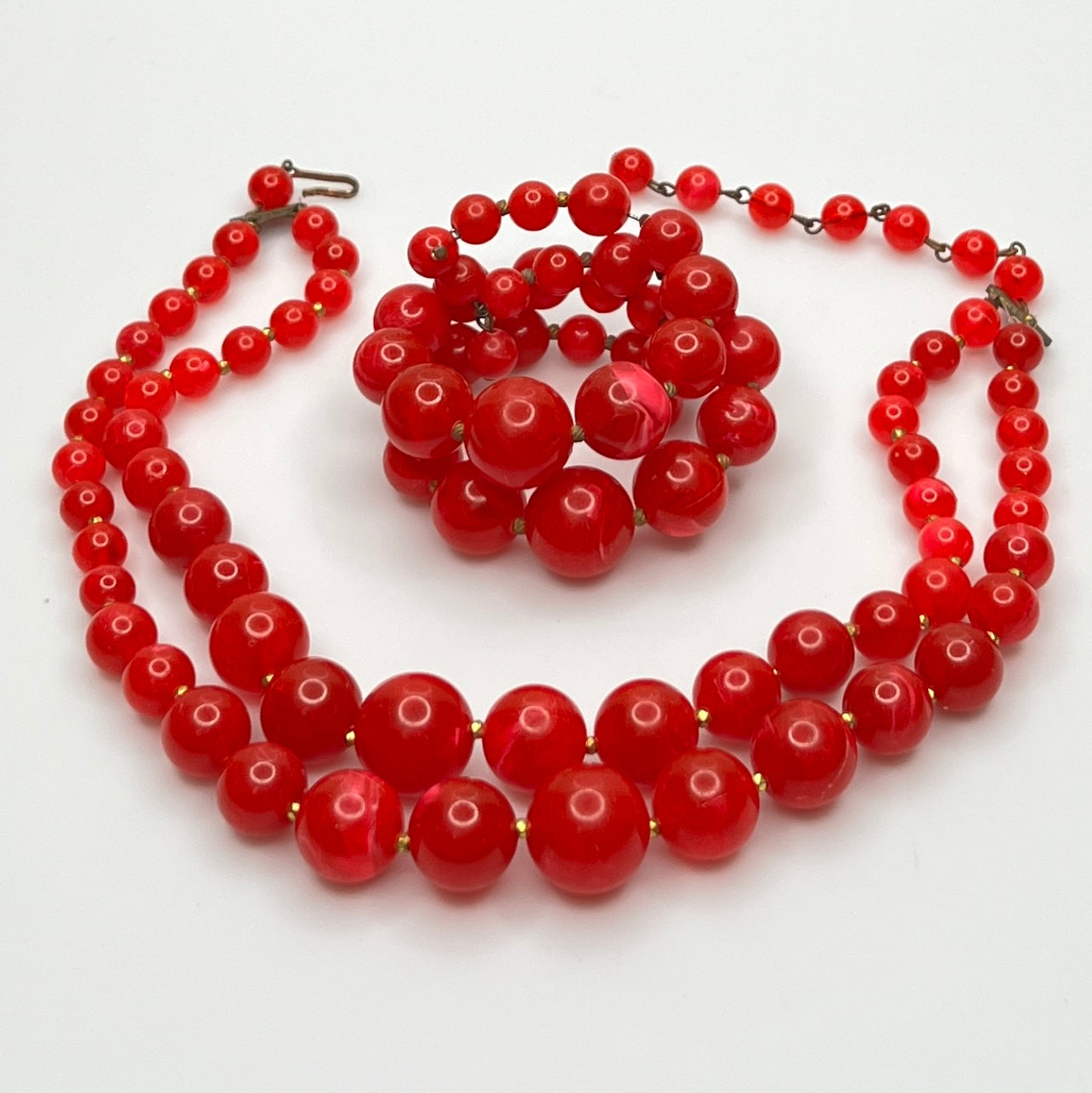 Red beaded necklace on a white background