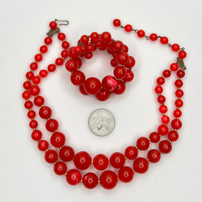Necklace and bracelet set laid flat beside a U.S. quarter for scale