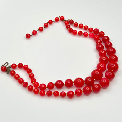 1960s Red lucite beaded necklace on a white background