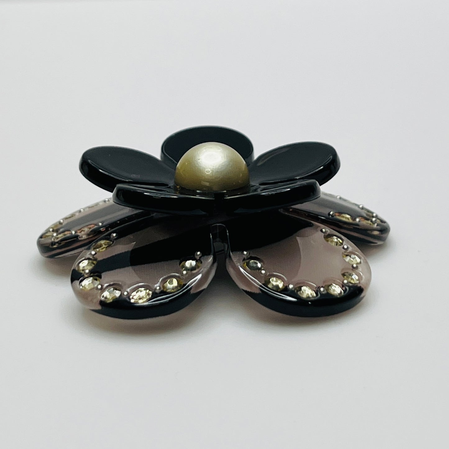 1970s black Lucite flower brooch with rhinestones and pearl center