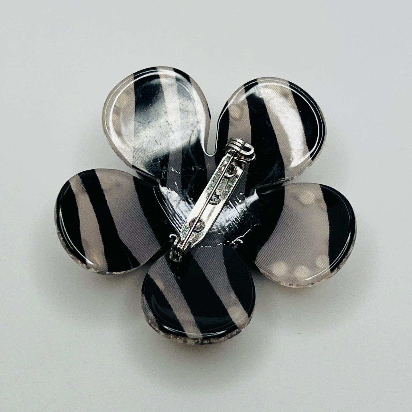 1970s black Lucite flower brooch with rhinestones and pearl center