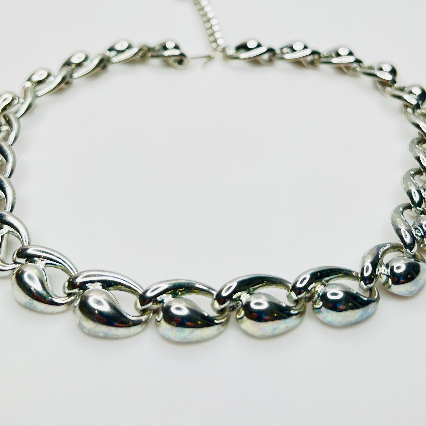 Close up detail of vintage mid century silver sculptural links